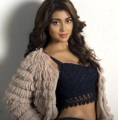 Shriya Saran Posing Confidently in Furry Jacket and Black Lace Crop Top image