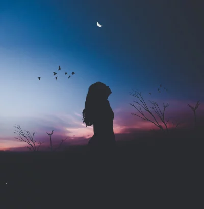 Dreamy Silhouette of Woman Under Crescent Moon in Ethereal Sunset Sky image