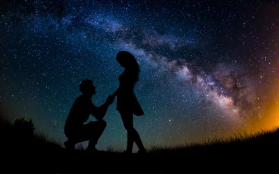 Romantic Proposal Under Milky Way Galaxy with Silhouetted Couple and Starry Night image