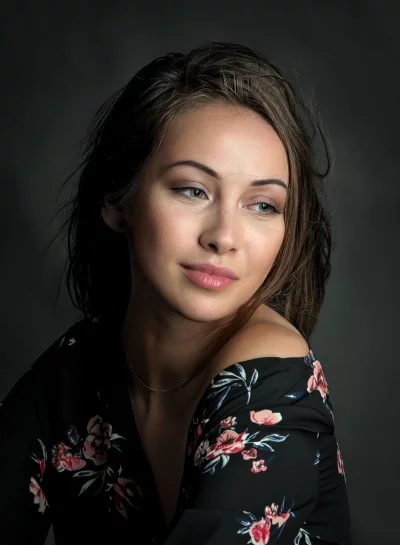 Elegant Young Woman in Floral Off-Shoulder Top Posing Thoughtfully image