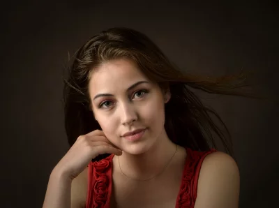 Serene Young Woman with Green Eyes and Windswept Hair Portrait image