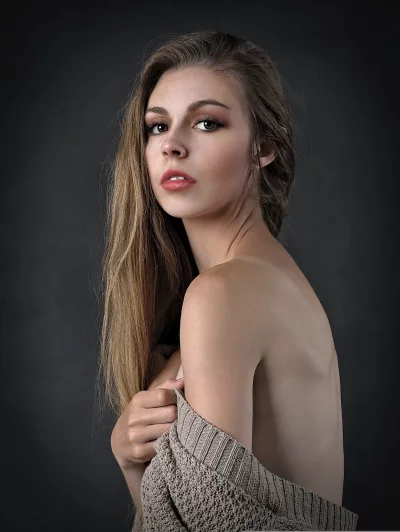 Captivating Young Woman in Knit Sweater with Intense Gaze image