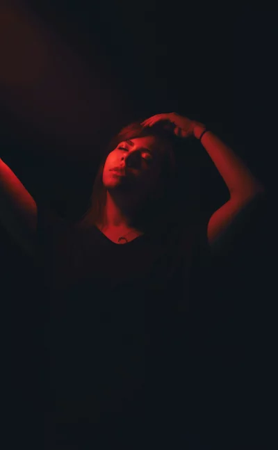 Captivating Woman Portrait Under Intense Red Studio Lighting