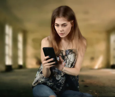 Focused Young Woman Scrolling Smartphone, Browsing Digital Content image