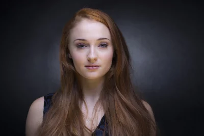 Captivating Redhead Woman Posing with Long Flowing Hair Studio Portrait image