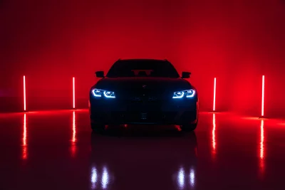 Sleek Red BMW Car with Illuminated Headlights Cinematic Wallpaper HD image