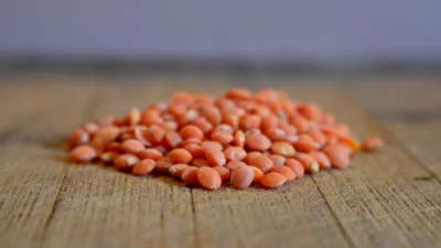 Healthy Raw Red Lentils Scattered on Rustic Wooden Surface for Cooking image
