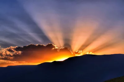 Dramatic Mountain Landscape with Radiant Crepuscular Rays at Sunset image