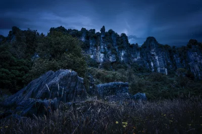 Dramatic Twilight Rock Formations with Starry Sky and Wild Grass image