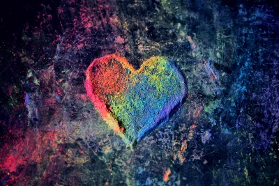 Vibrant Rainbow Powder Heart Symbol on Dark Textured Background for Love and Art image
