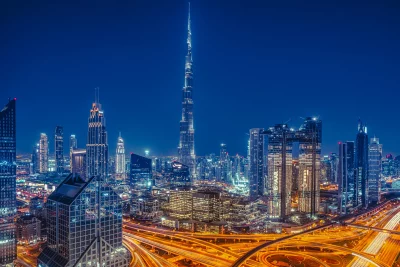 Dubai's Iconic Skyline with Burj Khalifa and Dynamic Highway Light Trails at Night image