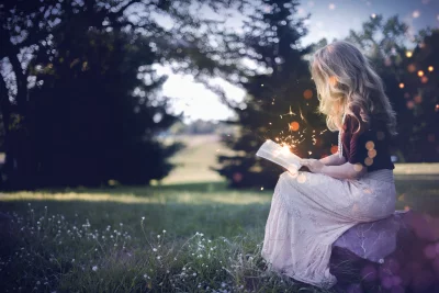 Enchanting Woman Reading Magical Book in Serene Twilight Meadow with Ethereal Sparks image