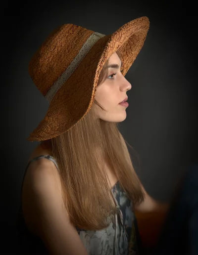 Thoughtful Young Woman in Profile with Straw Hat and Summer Dress image