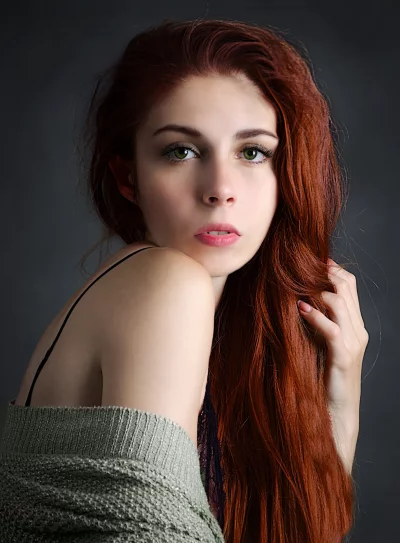 Elegant Redhead Portrait with Green Eyes and Flowing Auburn Hair image