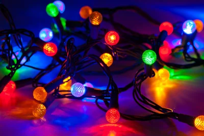 Vibrant Holiday String Lights Illuminating Dark Background with Reflective Glow image