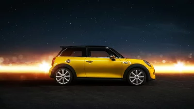 Stylish Yellow Compact Car on Asphalt Road at Night Under Starry Sky image