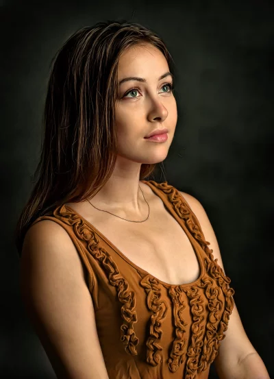Pensive Young Woman with Green Eyes and Flowing Hair in Studio Portrait image