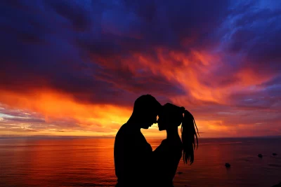 Couple's Romantic Silhouette Against Dynamic Ocean Sunset Sky image