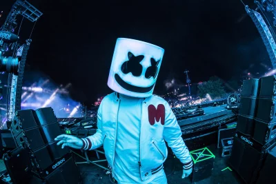 DJ Marshmello Energizes Outdoor Music Festival Stage with Iconic Helmet and Blue Lighting image
