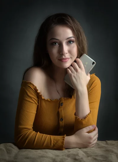 Fashionable Woman with Smartphone, Yellow Ribbed Top and Subtle Smile image