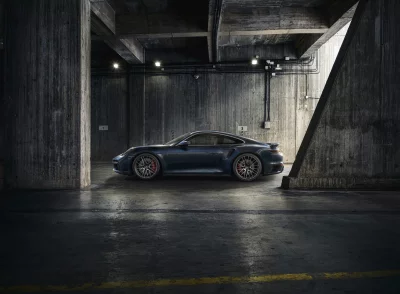 Luxury Dark Blue Porsche Sports Car in Concrete Parking Garage image