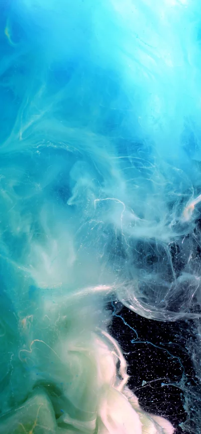 Abstract swirling turquoise and white ink in dark water