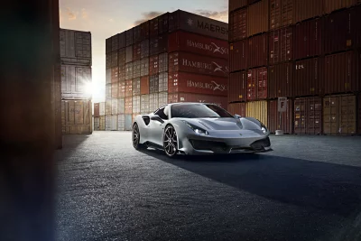 Sleek Silver Performance Sports Car in Industrial Shipping Port Setting at Sunset image