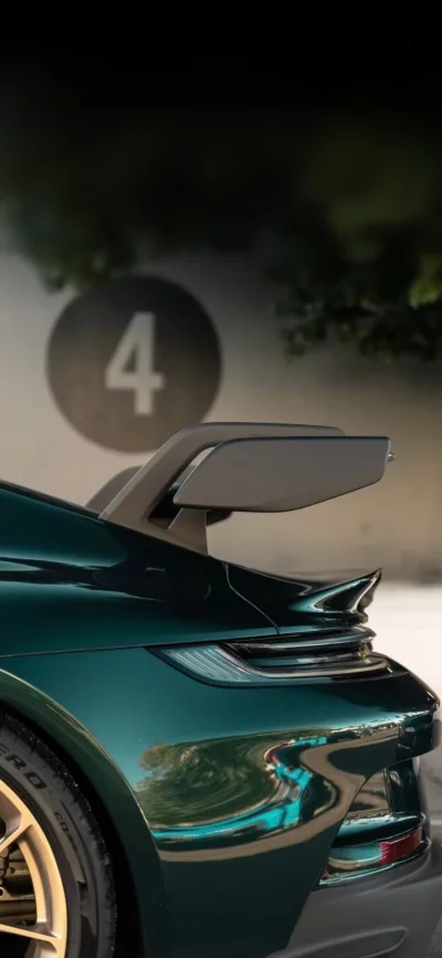 Dark Green Sports Car Rear View with Aerodynamic Spoiler and Gold Wheel image