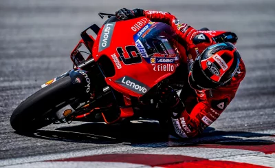 Dynamic MotoGP Racer Leaning into a High-Speed Turn on a Red Ducati Motorcycle image