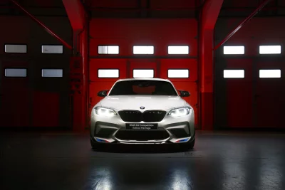 White BMW M2 Competition Edition Heritage Parked in Red Lit Garage image