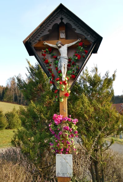 Ornate Wooden Wayside Cross with Jesus Christ Figure and Floral Adornments image