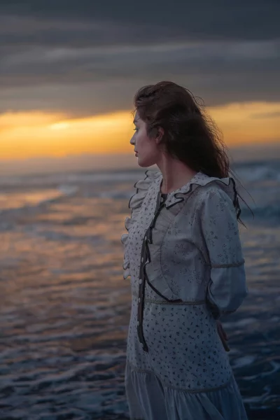 Vintage Woman on Beach at Golden Sunset