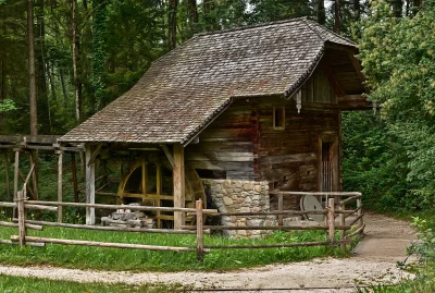 Rustic Wooden Watermill in Lush Green Forest, Historic Charm image