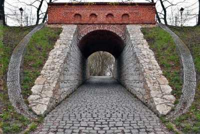 Historical Stone and Brick Archway Tunnel with Cobblestone Path Leading to Light image
