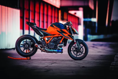 Dynamic Orange and Black Sport Motorcycle Parked on Stand at Racetrack Ready for High-Speed Adventure image