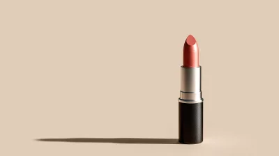 Elegant Coral Lipstick with Metallic Finish on Minimalist Beige Background
