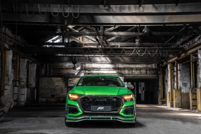 Vibrant Green Audi ABT SUV Cinematic Car Photography Dark Industrial Setting High Performance Wallpaper image