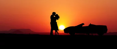 Romantic Sunset Kiss with Convertible Car Silhouette in Desert image