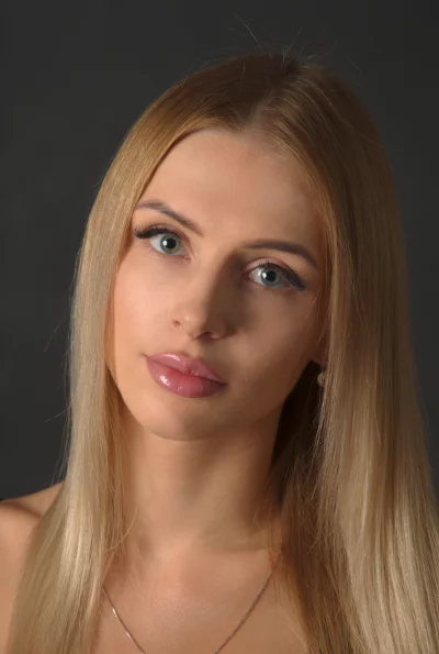 Captivating Young Woman with Blue-Green Eyes and Blonde Hair image