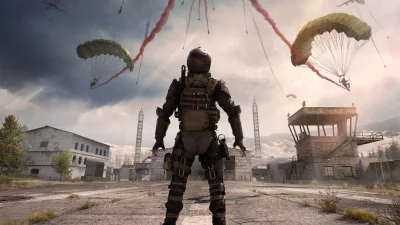 Vanguard on lookout as paratroopers deploy with red smoke over a desolate facility image