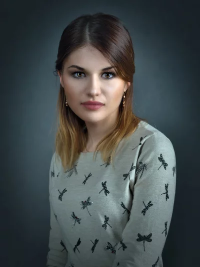 Elegant Woman with Dragonfly Patterned Sweater and Expressive Eyes image