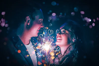 Young Couple Celebrating Love with Sparkler and Romantic Bokeh Lights Cinematic Wallpaper image
