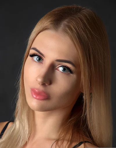 Blonde Woman with Intense Blue Eyes and Pink Lips Gazing at Camera image