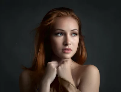 Serene Redhead Woman with Clasped Hands, Pensive Gaze image