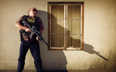 Vigilant DEA Agent in Tactical Vest with Assault Rifle on Urban Patrol image