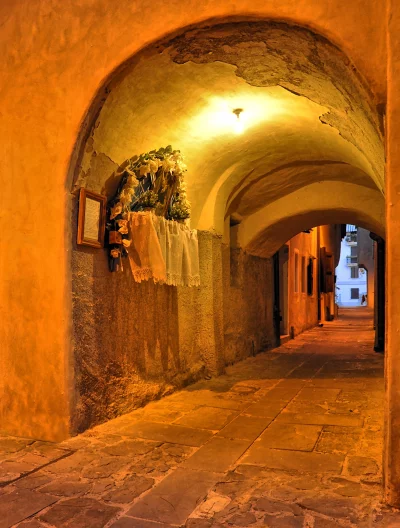 Historic Arched European Alleyway Illuminated by Warm Night Light image