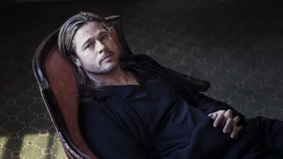 Brad Pitt Lounging in Ornate Chair with Contemplative Gaze image