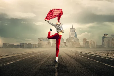 Energetic Woman Dancing with Red Scarf in Urban Cityscape image