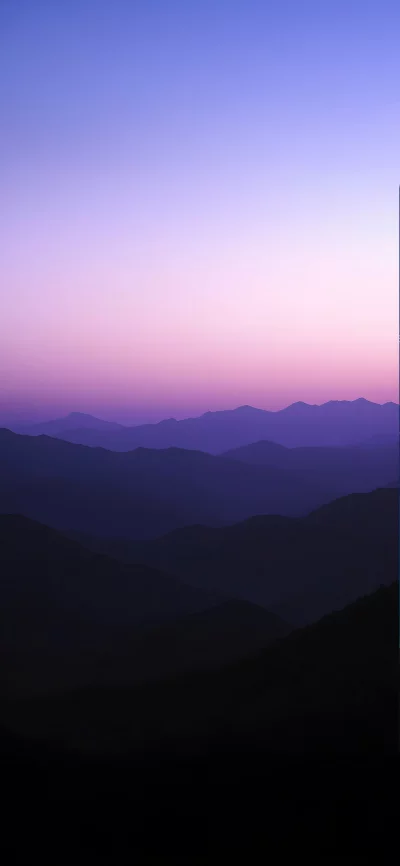 Majestic Mountain Range Silhouette at Twilight with Vibrant Gradient Sky image