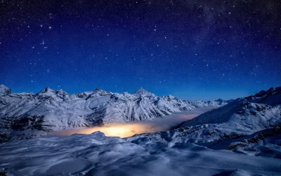 Starry Night Over Snowy Mountains and Glowing Valley Mist, Alpine Winter Landscape image